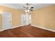 Bedroom featuring wood-look floors, two white doors, and a ceiling fan at 6317 Palmas Bay Cir, Port Orange, FL 32127