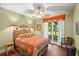 Cozy bedroom featuring a ceiling fan, access to an outdoor patio, and bright, natural light throughout at 6317 Palmas Bay Cir, Port Orange, FL 32127