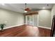 Large bedroom with ceiling fan, hardwood floors, sliding glass door, and neutral paint at 6317 Palmas Bay Cir, Port Orange, FL 32127