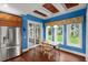 Cozy dining area features stainless steel refrigerator and backyard view at 6317 Palmas Bay Cir, Port Orange, FL 32127