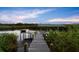 Picturesque waterfront dock featuring a covered boat lift and ample space for relaxation at 6317 Palmas Bay Cir, Port Orange, FL 32127
