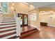 Welcoming foyer with hardwood floors, staircase, and double front doors featuring a wreath at 6317 Palmas Bay Cir, Port Orange, FL 32127