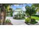Beautiful home with circular driveway, lush green lawn, mature trees, and well-manicured landscaping at 6317 Palmas Bay Cir, Port Orange, FL 32127