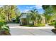Stunning home with a circular driveway, mature palm trees, and well-maintained landscaping at 6317 Palmas Bay Cir, Port Orange, FL 32127