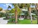 Charming home with lush landscaping, a circular driveway, and a welcoming front porch at 6317 Palmas Bay Cir, Port Orange, FL 32127