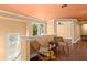 Upstairs hallway with hardwood floors, bright windows, and comfortable seating, creating a cozy and inviting atmosphere at 6317 Palmas Bay Cir, Port Orange, FL 32127