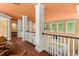 Spacious hallway with hardwood floors, white columns, and natural light streaming through the windows at 6317 Palmas Bay Cir, Port Orange, FL 32127