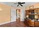 Cozy office space with custom built-ins, ceiling fan, and access to the upstairs hallway at 6317 Palmas Bay Cir, Port Orange, FL 32127