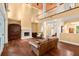 Expansive living room boasts hardwood floors, a fireplace, and views of the second-story balcony, creating a grand atmosphere at 6317 Palmas Bay Cir, Port Orange, FL 32127