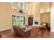 Cozy living room featuring hardwood floors, a fireplace, and sliding doors for an airy, inviting atmosphere and backyard view at 6317 Palmas Bay Cir, Port Orange, FL 32127