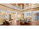 Spacious living area with hardwood floors, a fireplace, and a view of the open floor plan and second story balcony at 6317 Palmas Bay Cir, Port Orange, FL 32127