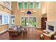 Bright living room with hardwood floors, fireplace, and sliding glass doors leading to a spacious, landscaped backyard at 6317 Palmas Bay Cir, Port Orange, FL 32127