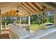 This outdoor kitchen features a grill and a ceiling fan under a covered structure at 6317 Palmas Bay Cir, Port Orange, FL 32127