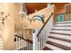 Staircase with wood handrail and white risers, bright hallway, and unique fish decor at 6317 Palmas Bay Cir, Port Orange, FL 32127
