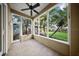 Bright sunroom with large windows offering serene views of the beautifully landscaped backyard and an outdoor gazebo at 6317 Palmas Bay Cir, Port Orange, FL 32127