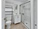 This bathroom features a toilet, shelf, vanity, and glass enclosed shower with a handheld shower head at 636 W Mathis St, Deland, FL 32720
