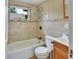 This bathroom features tile flooring, a window, a combination tub and shower, and a vanity at 636 W Mathis St, Deland, FL 32720