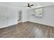 Spacious bedroom with wood-look flooring, ceiling fan, and view to the bathroom at 636 W Mathis St, Deland, FL 32720