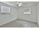 This bedroom has neutral paint and tile floors with two windows providing natural light at 636 W Mathis St, Deland, FL 32720
