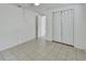 This bedroom has tile flooring, neutral paint, and a closet with bi-fold doors at 636 W Mathis St, Deland, FL 32720