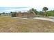 Angle of the exterior elevation with brick facade, screened in porch, and driveway at 636 W Mathis St, Deland, FL 32720