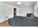 Cozy living room with fresh white paint, new flooring, and a comfortable gray sectional sofa at 636 W Mathis St, Deland, FL 32720