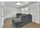 Bright living room featuring new floors, a spacious gray sectional, and lots of natural light at 636 W Mathis St, Deland, FL 32720
