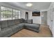 Inviting living room featuring a large sectional, new floor, and large window at 636 W Mathis St, Deland, FL 32720