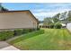 Backyard with ample green space and manicured hedges at 672 Swarthmore Dr, Deland, FL 32724