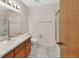 Bathroom with tiled floor, white vanity and sink, toilet, and glass enclosed shower at 672 Swarthmore Dr, Deland, FL 32724