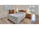 Comfortable bedroom with shuttered windows, wood-look floors and a classic quilt at 672 Swarthmore Dr, Deland, FL 32724