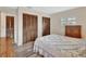 Bright bedroom featuring shuttered windows, wood-look floors and closet at 672 Swarthmore Dr, Deland, FL 32724