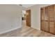 Bright bedroom with wood-look flooring, closet, and open doorway to other living areas at 672 Swarthmore Dr, Deland, FL 32724