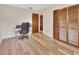 Bedroom with wood-look flooring, closet, and desk space, offering functionality at 672 Swarthmore Dr, Deland, FL 32724