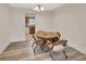 Cozy dining area with wood floors, natural light, and access to the kitchen at 672 Swarthmore Dr, Deland, FL 32724