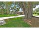 Charming single-story brick home with a well-manicured lawn and mature shade trees at 672 Swarthmore Dr, Deland, FL 32724