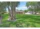 Spacious yard with mature trees surrounding a brick home at 672 Swarthmore Dr, Deland, FL 32724