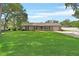 Charming single-story brick home with a well-manicured lawn and attached garage at 672 Swarthmore Dr, Deland, FL 32724