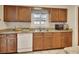 Kitchen featuring wood cabinets, granite countertops, and stainless steel appliances at 672 Swarthmore Dr, Deland, FL 32724