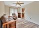Cozy living room with wood-look floors and natural light, open to kitchen at 672 Swarthmore Dr, Deland, FL 32724