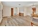 Open-concept living space with hardwood floors, neutral walls, and access to the kitchen at 672 Swarthmore Dr, Deland, FL 32724