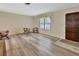 Living room with hardwood floors, natural light, and neutral-colored walls at 672 Swarthmore Dr, Deland, FL 32724
