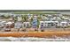 Aerial view showcasing a blue home within a lively beachfront neighborhood at 6847 S Atlantic Ave, New Smyrna Beach, FL 32169