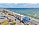Beachfront blue home that is surrounded by neighborhood homes at 6847 S Atlantic Ave, New Smyrna Beach, FL 32169