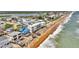 An aerial view of the street and neighborhood next to a beach at 6847 S Atlantic Ave, New Smyrna Beach, FL 32169