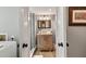 Beautifully updated bathroom features a glass shower and vanity with wooden cabinetry and ample lighting at 6847 S Atlantic Ave, New Smyrna Beach, FL 32169