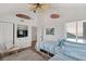 Comfortable bedroom featuring twin beds, a built-in TV cabinet, and charming coastal decorations at 6847 S Atlantic Ave, New Smyrna Beach, FL 32169