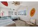 Bright bedroom with twin beds, coastal decor, and large windows offering serene views at 6847 S Atlantic Ave, New Smyrna Beach, FL 32169
