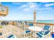 Spacious deck area with ocean views and a variety of seating arrangements at 6847 S Atlantic Ave, New Smyrna Beach, FL 32169