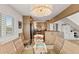 Elegant dining room with a view to the kitchen and stylish chandelier lighting at 6847 S Atlantic Ave, New Smyrna Beach, FL 32169